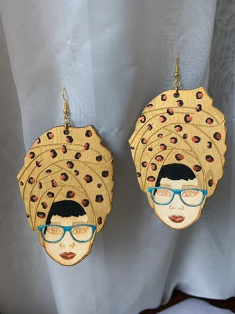 Headwrap lady with gold Leopard print head wrap, blue topaz glasses and a bronze pout wood earrings, wood earrings, Afro lady inspired